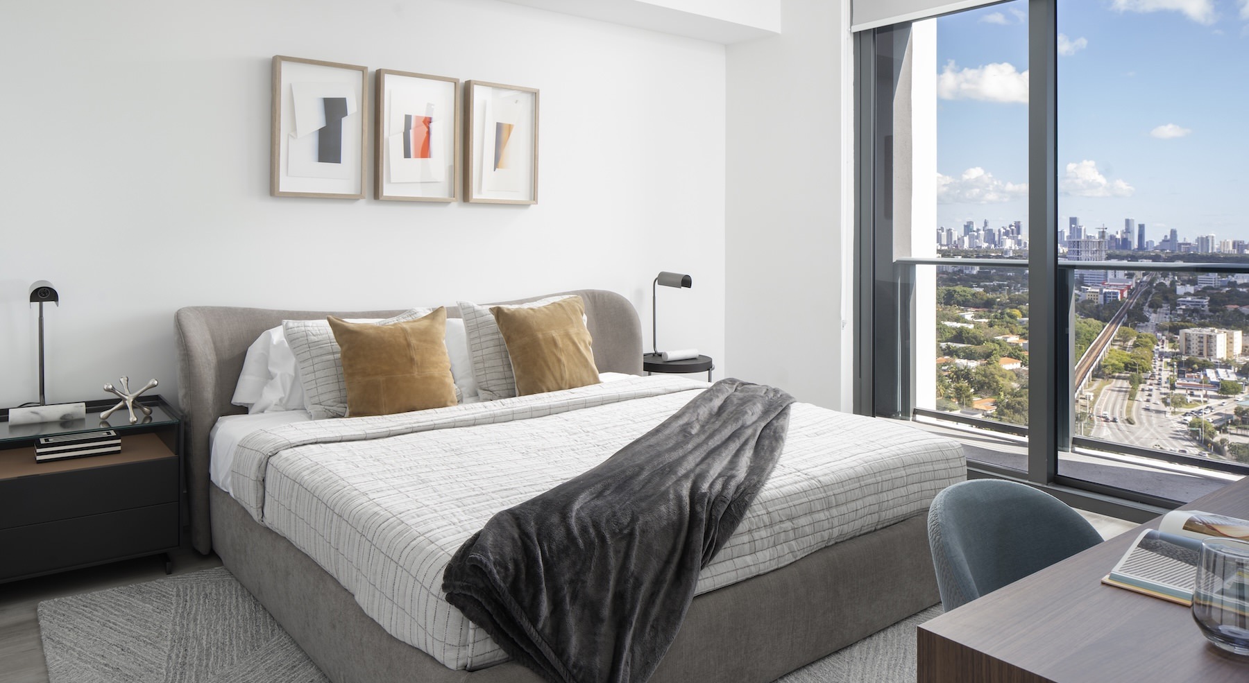 a bed in a room with side tables and a large window