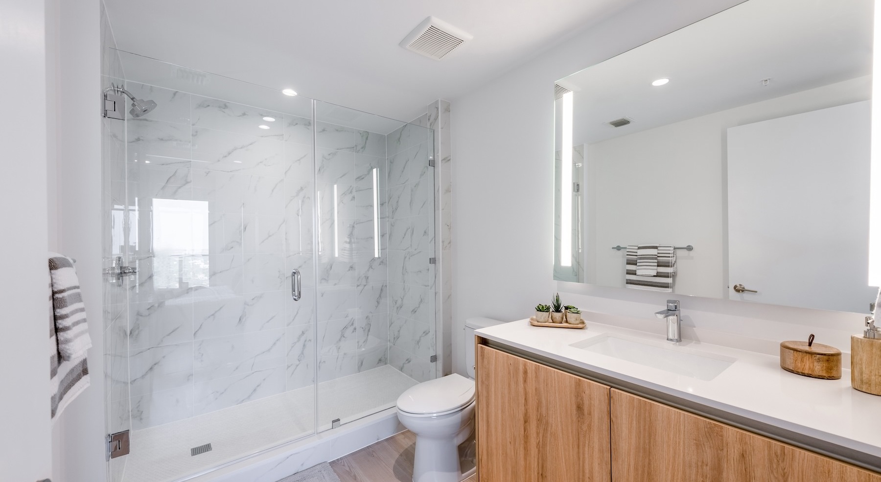 bathroom with a large sink and mirror and a walk-in shower