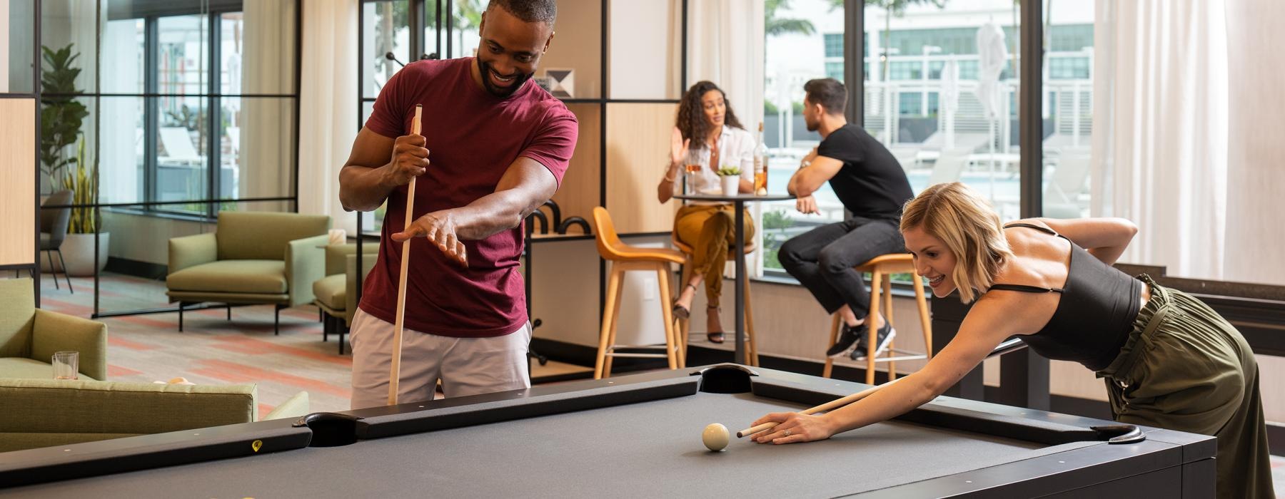 a group of people playing pool