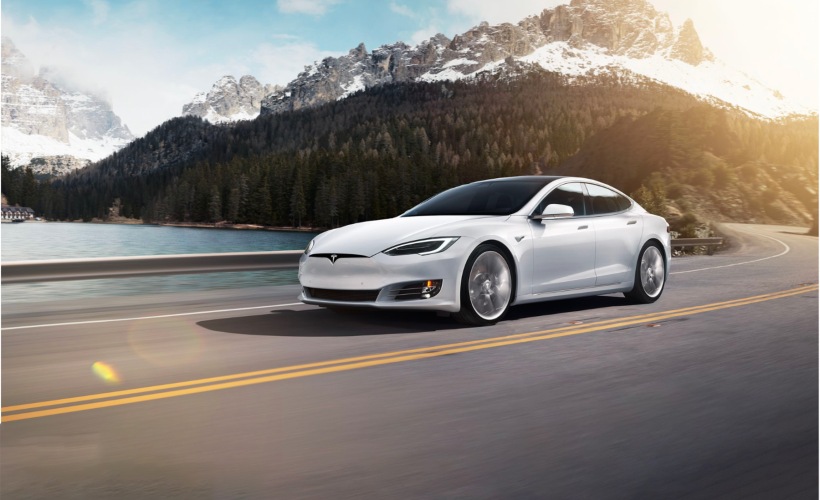 a white car driving outdoors 