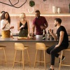 a group of people standing around a bar