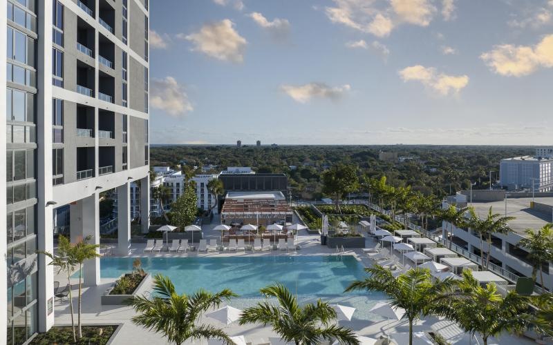 a pool next to a building with a city view